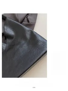 Close-up of black leather material with soft pebble texture and durable matte finish
