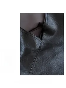 Detailed macro view showing lychee pattern leather and double stitching on black tote bag