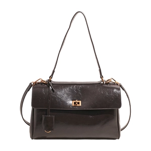 Retro deep brown leather shoulder bag with gold twist lock and adjustable strap