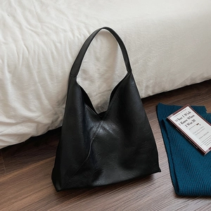Large black faux leather tote bag with lychee texture and stitching for daily commute