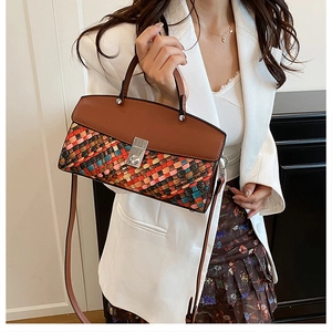 Detail of vintage woven handbag featuring colorful textures and silver metal twist lock
