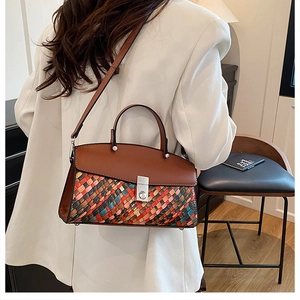 Detail of multi-color woven handbag with silver turn-lock and brown leather flap