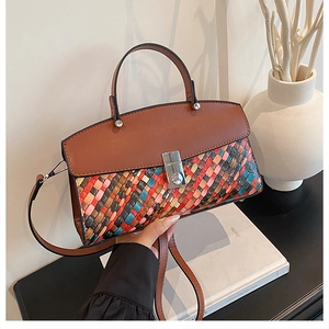 Detail of the woven geometric pattern and silver twist lock on this multi-color handbag