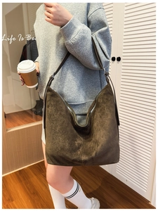 Detail of the high-quality dark brown suede Hobo bag with adjustable shoulder strap