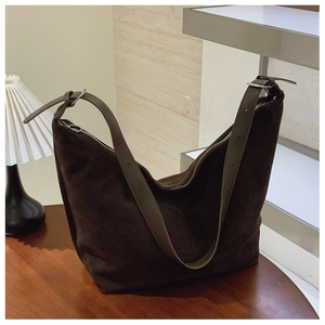 Detailed view of large dark coffee suede hobo bag with a thick matte leather texture