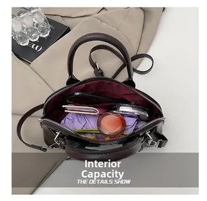 Internal view of dark brown crocodile-embossed shell bag showing spacious storage capacity