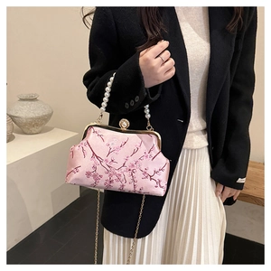 Detail of pink satin bag with plum blossom embroidery and pearl handle strap