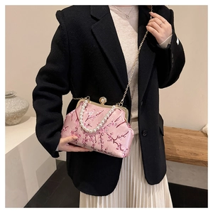 Detail of pink satin evening bag with cherry blossom embroidery and pearl clasp