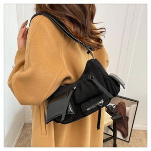 Detail of black multi-pocket shoulder bag in mixed matte suede and shiny patent leather