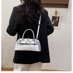 Silver crocodile texture shell bag worn by model showing actual size and shiny finish