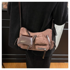 Close-up of vintage brown oil wax leather crossbody bag with multiple utility pockets