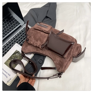 Detail of retro patchwork shoulder bag with brown suede and dark leather multi-pockets