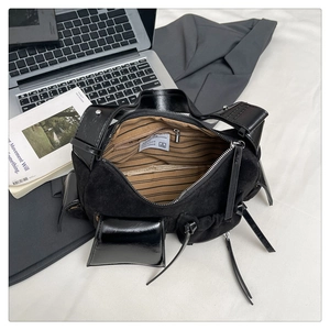 Detailed top view of black multi-pocket handbag with brown striped lining and zip closure