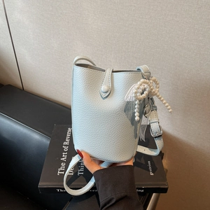 Light blue lychee leather bucket bag with pearl charm and silver buckle strap