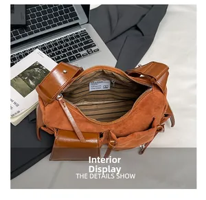 Detail view of the spacious striped interior and suede patchwork design of the handbag