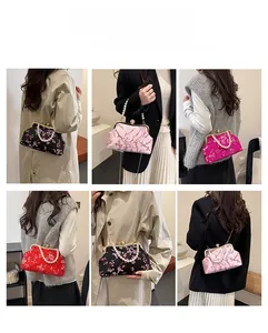 Detail of embroidered silk evening bags with pearl handles in multiple colors and styles