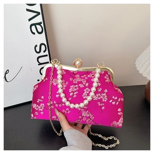 Detail of rose red silk evening bag with peach blossom embroidery and pearl handle