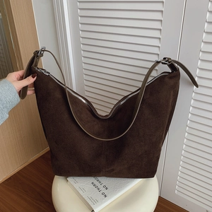 Deep brown suede hobo bag with adjustable shoulder strap and silver zipper closure