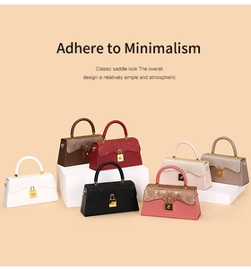 Multi-color minimalist handbag collection with gold clasps on geometric display pedestals