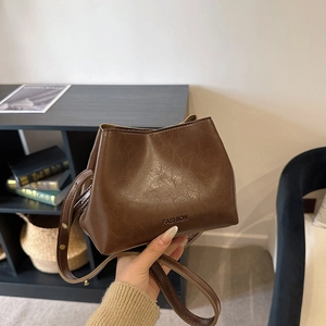 Vintage brown leather bucket handbag with FASHION lettering and long crossbody strap