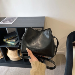 Minimalist black PU leather bucket bag with fashion embossing and natural wrinkled texture