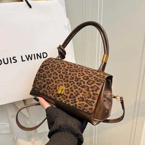 Leopard print and brown leather bowling handbag with gold metal clasp and dual handles