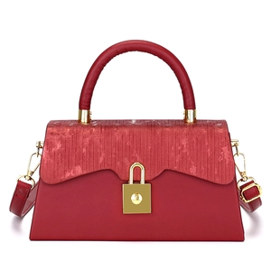 Classic red box crossbody handbag with textured flap and golden metal hardware on white background