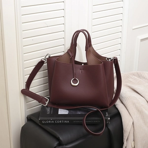 Retro burgundy pebble leather tote bag with silver ring detail and adjustable strap