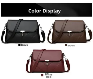 Leather crossbody bag detail showing leaf charm in black, brown and wine red