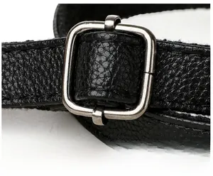 Detailed macro shot of black litchi grain leather strap with silver adjustable buckle