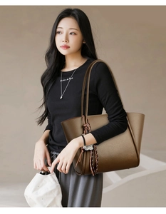 Deep brown oversized tote bag in pebbled leather with stylish woven tassel detail