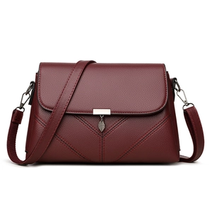 Fashionable wine red crossbody bag with lychee texture and leaf pendant detail