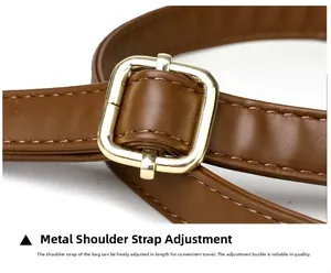 Detail of brown litchi grain leather strap with gold metal adjustment buckle