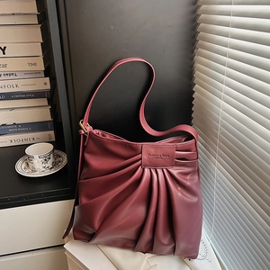 Vintage burgundy leather underarm bag with fan-shaped pleats and adjustable strap
