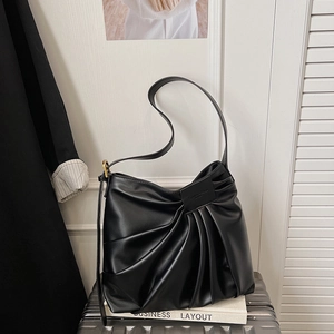French vintage black pleated underarm bag with adjustable shoulder strap on neutral background