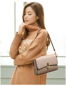 Close-up of litchi texture faux leather on khaki shoulder bag with metal buckle