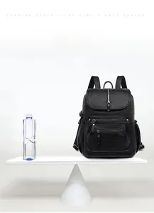 Visual demonstration of the lightweight 0.6kg black leather backpack on a balance scale
