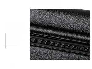 Detail shot of black lychee grain leather texture with precise stitching and zipper
