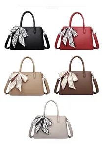 Detailed color display of faux leather handbags with decorative scarves and straps