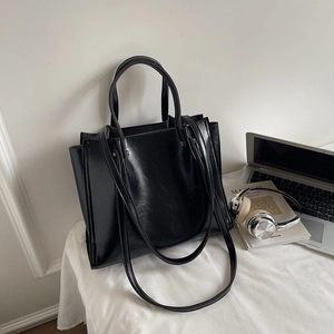 Minimalist black large capacity tote bag in glossy PU leather with dual handle straps