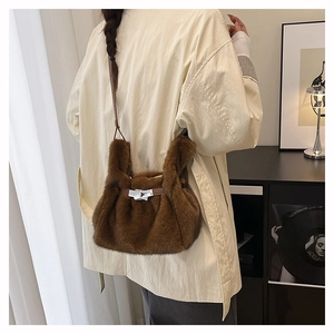 Detail of plush faux fur shoulder bag with leather strap and silver twist lock