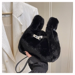Detail of black faux fur handbag with leather strap and silver metal twist lock closure