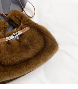 Detailed close-up of brown faux fur texture and silver metal twist lock on the handbag