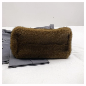 Detailed base of brown faux fur crossbody bag showing smooth seams and plush texture