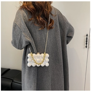 White bubble texture acrylic clutch bag with gold bead handle and chain strap
