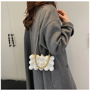 Modern white bubble texture acrylic shoulder bag with gold chain and beaded handle on a model