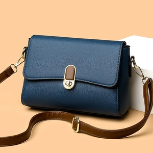 Navy blue lychee leather shoulder bag with brown strap and gold twist lock closure