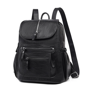 Front view of black pebble leather backpack with silver zippers on white background