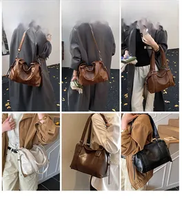 Detail showing vintage leather tote bag worn by model in brown, cream and black colors