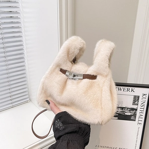Chic cream faux fur mini crossbody bag with brown leather strap and silver clasp